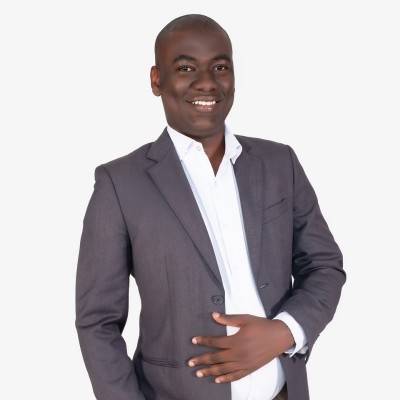 A professional headshot of Daniel Kitwa, the founder of TSE, smiling confidently and looking directly at the camera. He is wearing a suit jacket and a light-colored shirt.